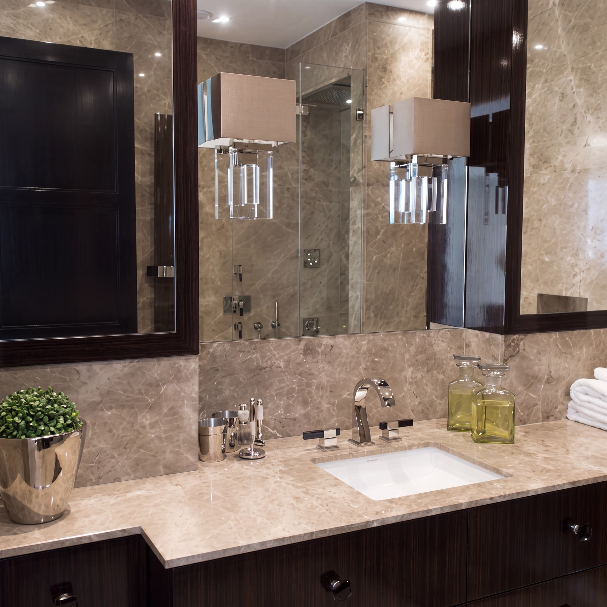 Designer bathroom vanity with mirror wall and marble worktop