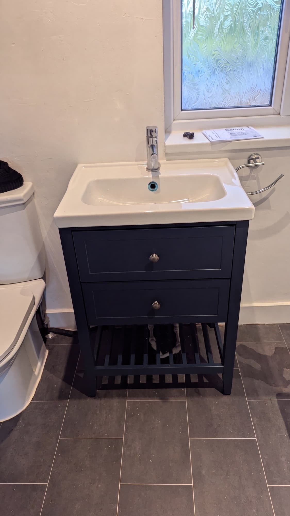 New navy blue vanity unit in a refurbished bathroom