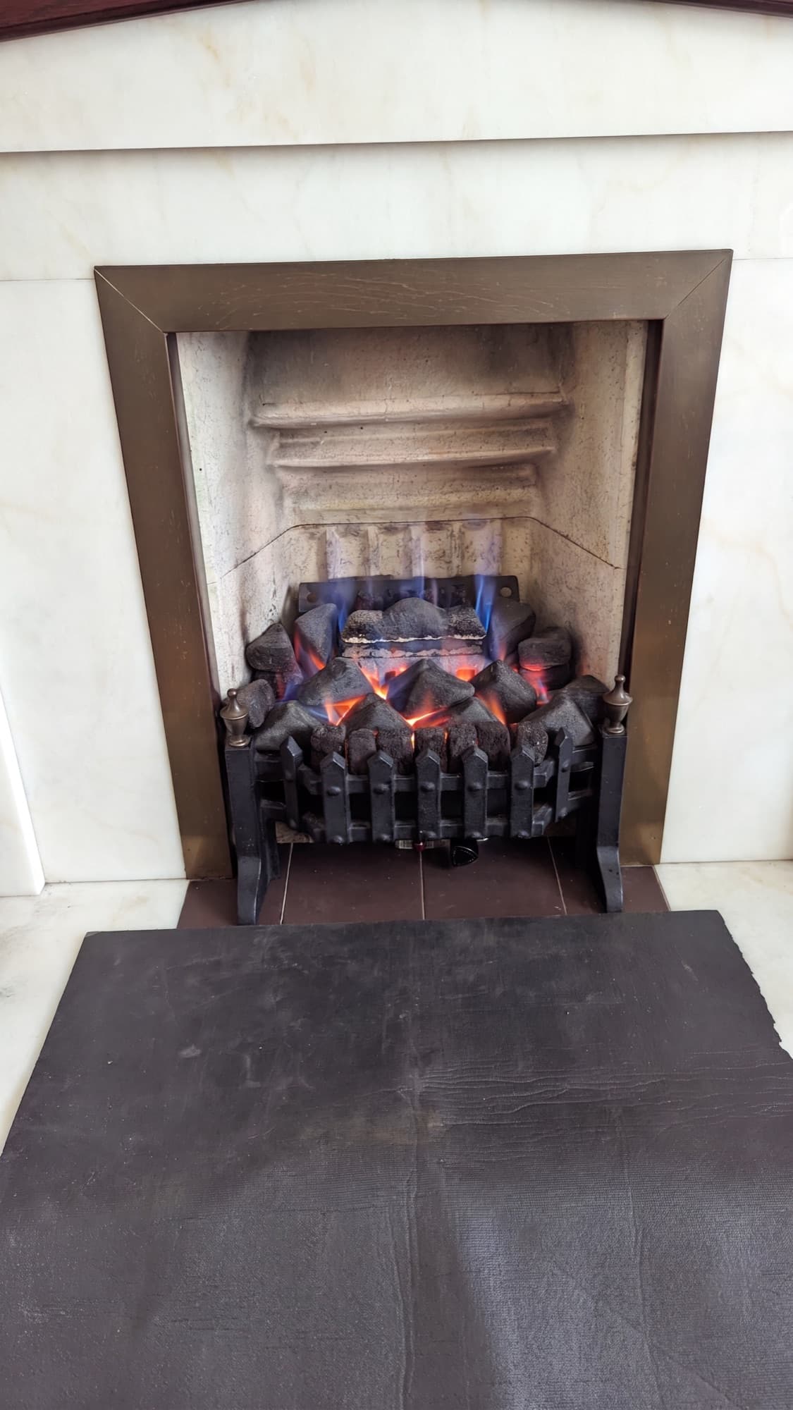 Gas fire burning in a marble fireplace